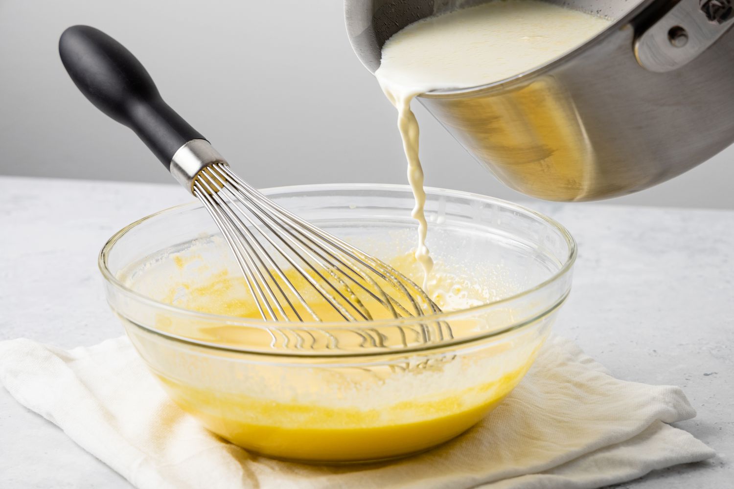 Milk Poured into Bowl of Vanilla Custard Egg Mixture