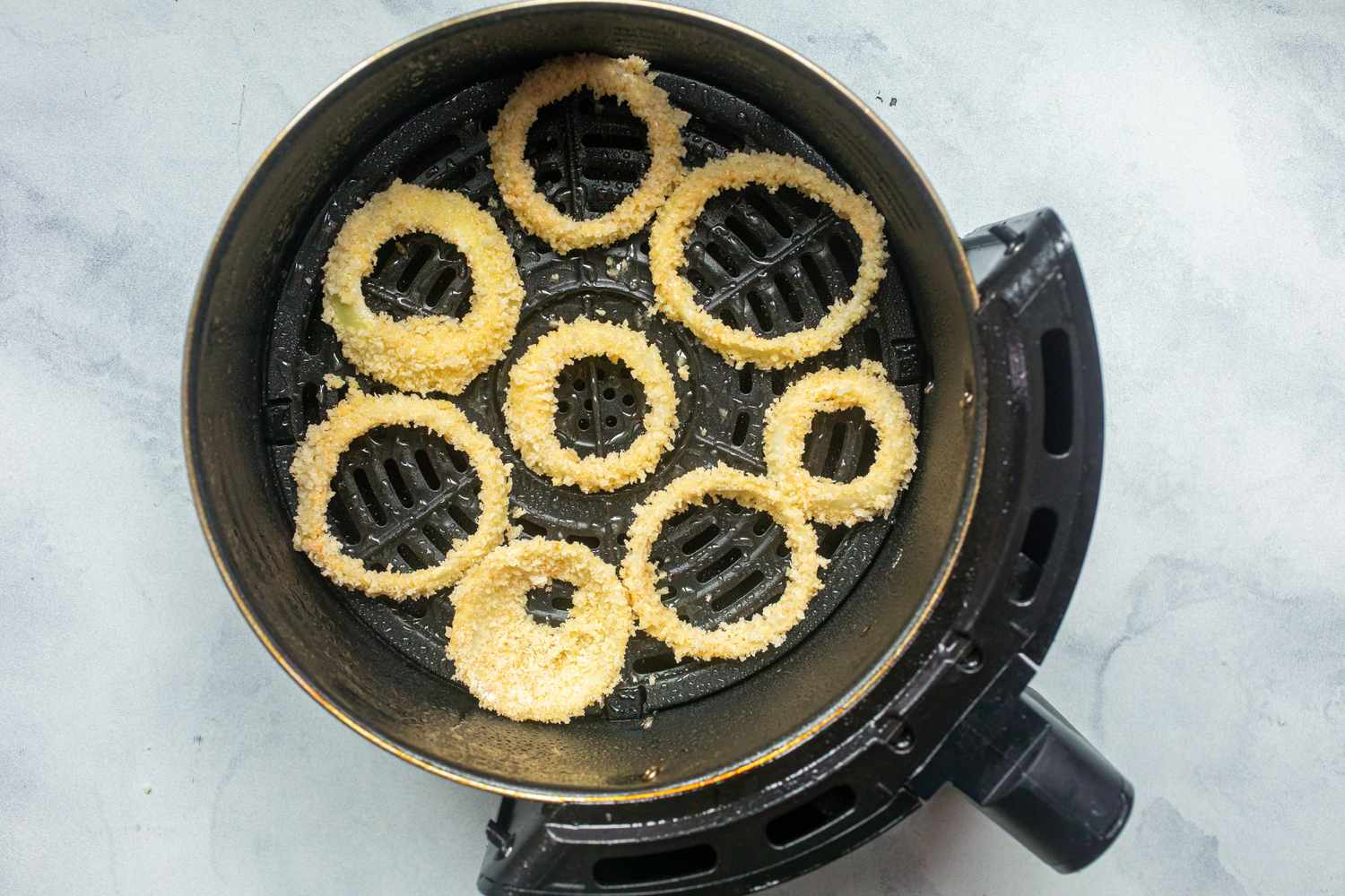 Onion rings in an air fryer.