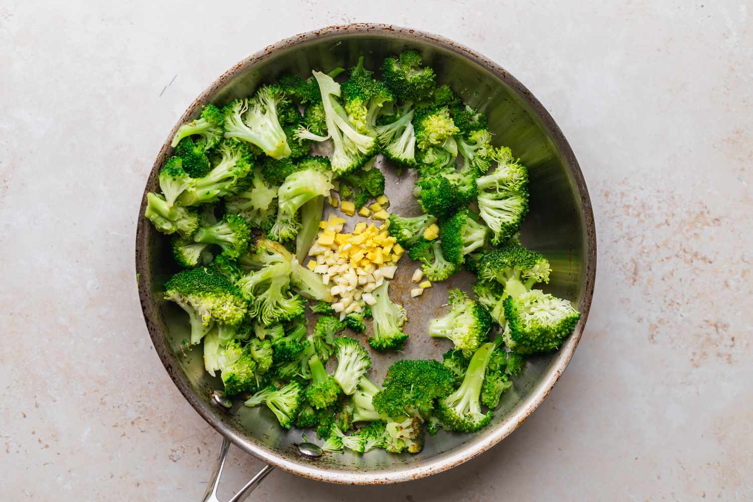 Making broccoli stir fry in a wok.