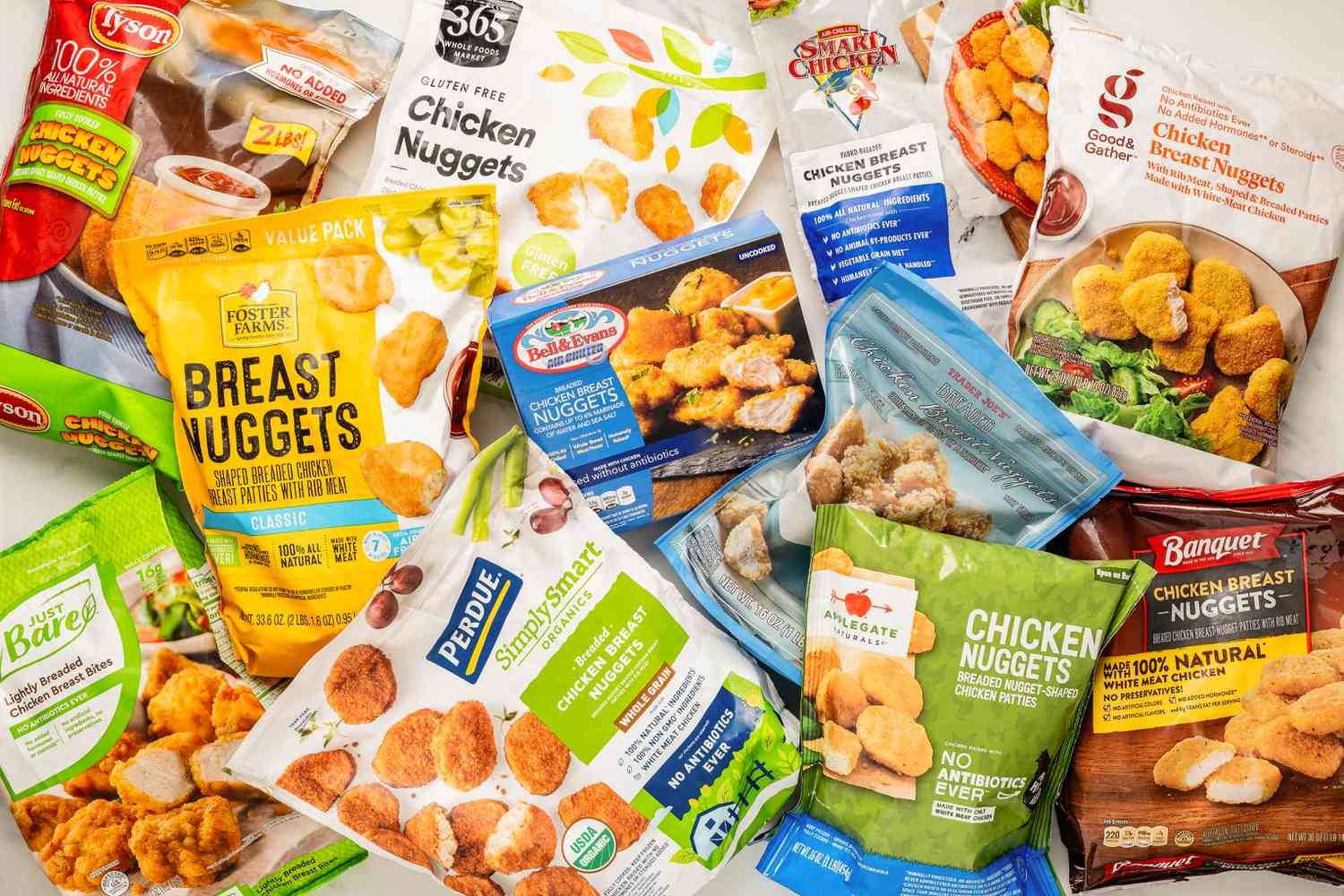 Different brands of chicken nuggets (still in the bag) splayed on a counter