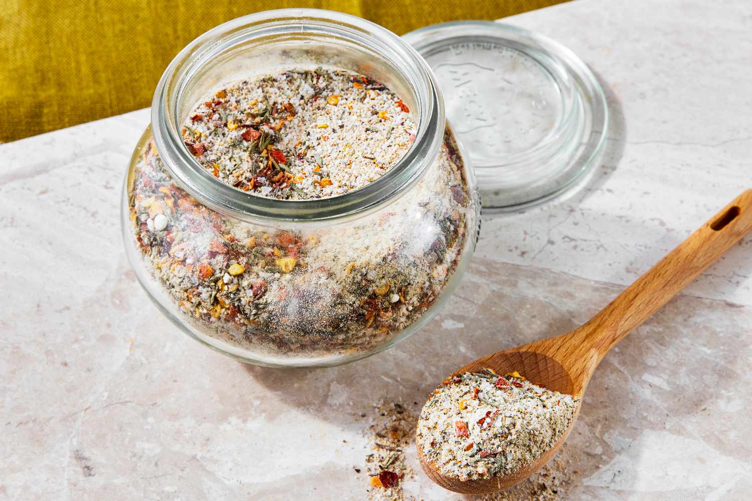 Jar of Steak Seasoning Next to a Spoonful on the Counter