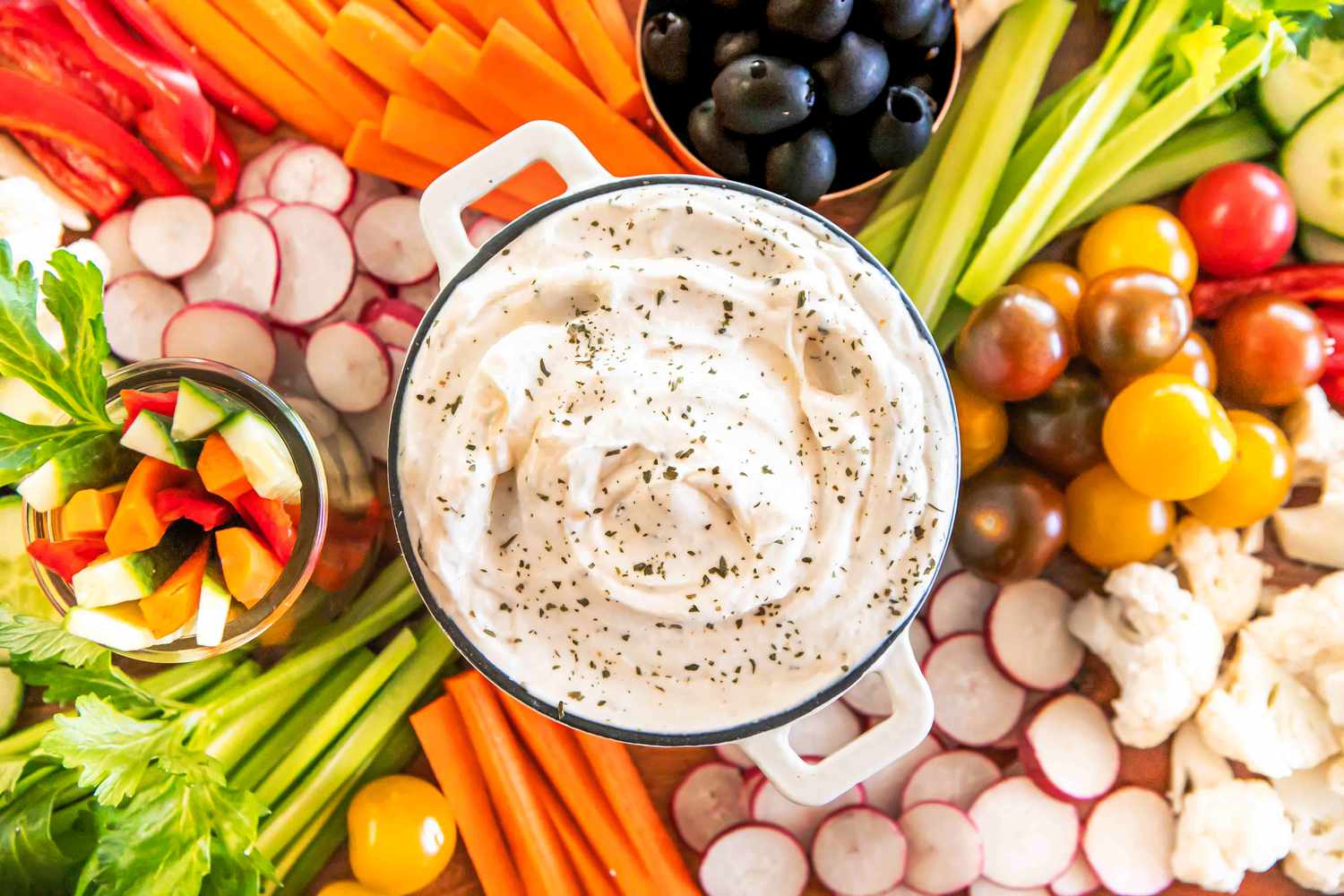 ranch dip in a mini dutch oven on a tray with vegetables