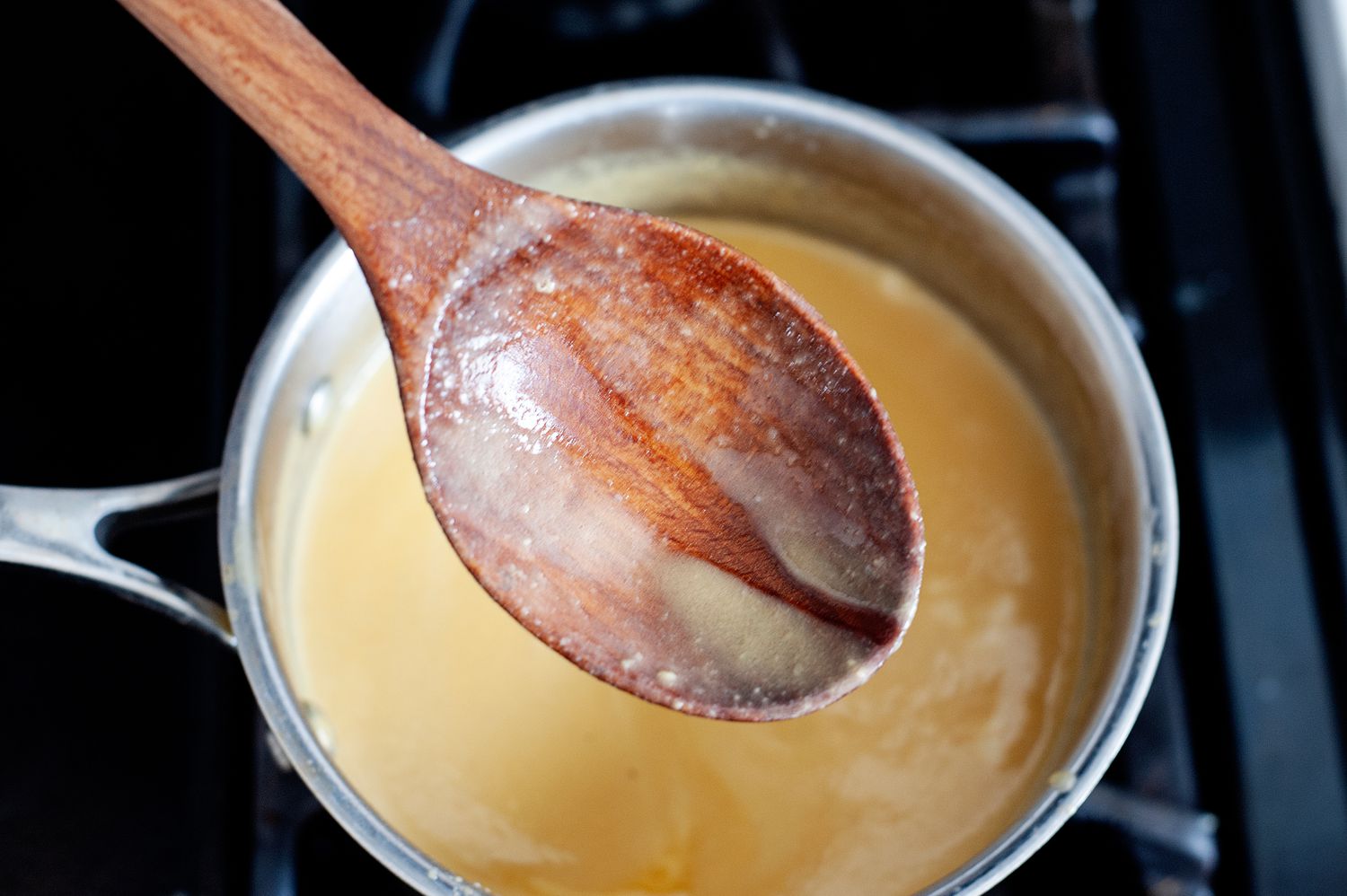 Thickening ice cream base on the stove for a butter pecan ice cream recipe.