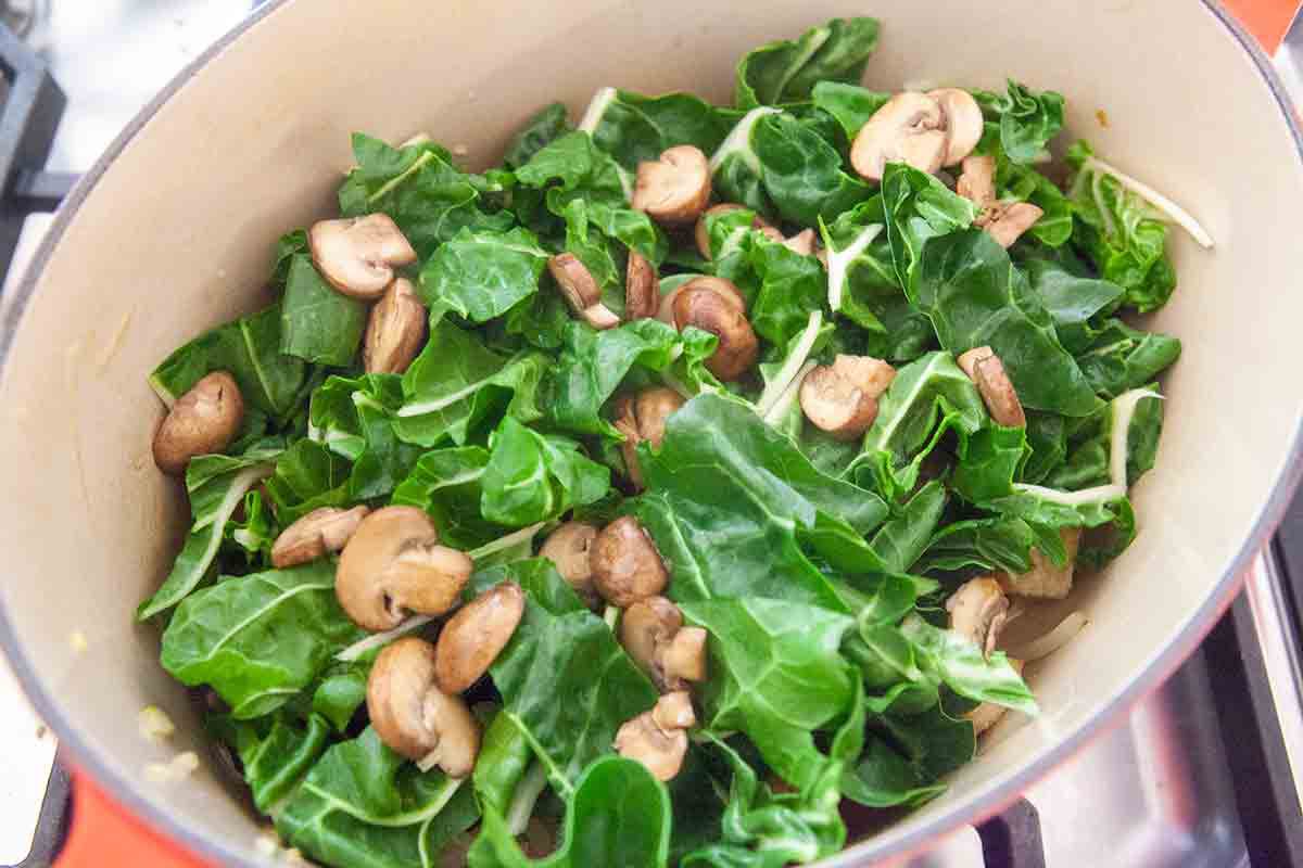 layer chard and mushrooms over bread and onions in dutch oven for panade