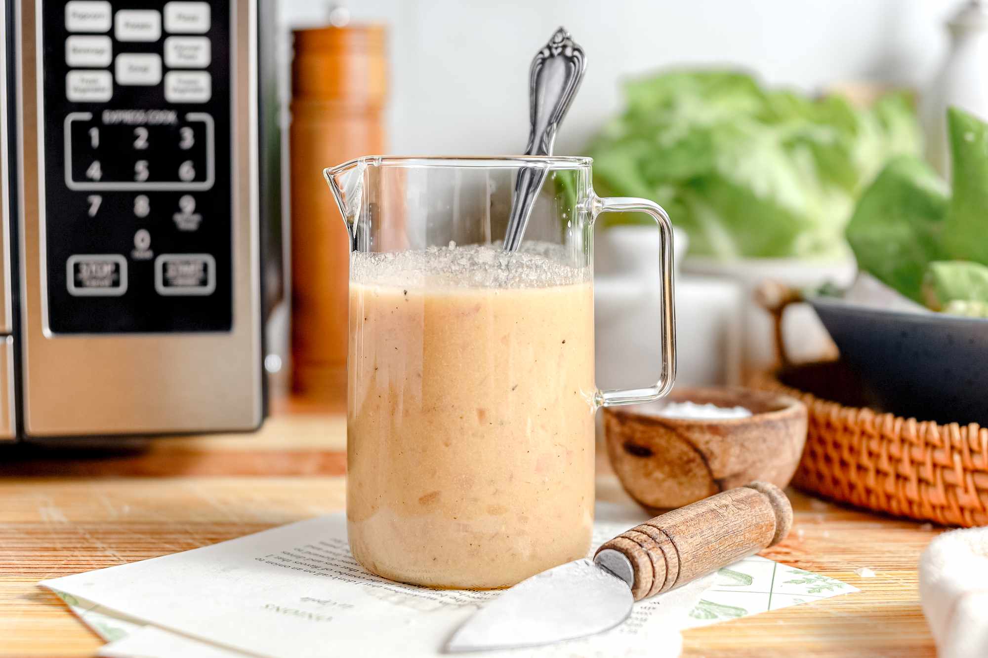 salad dressing in a jar next to microwave