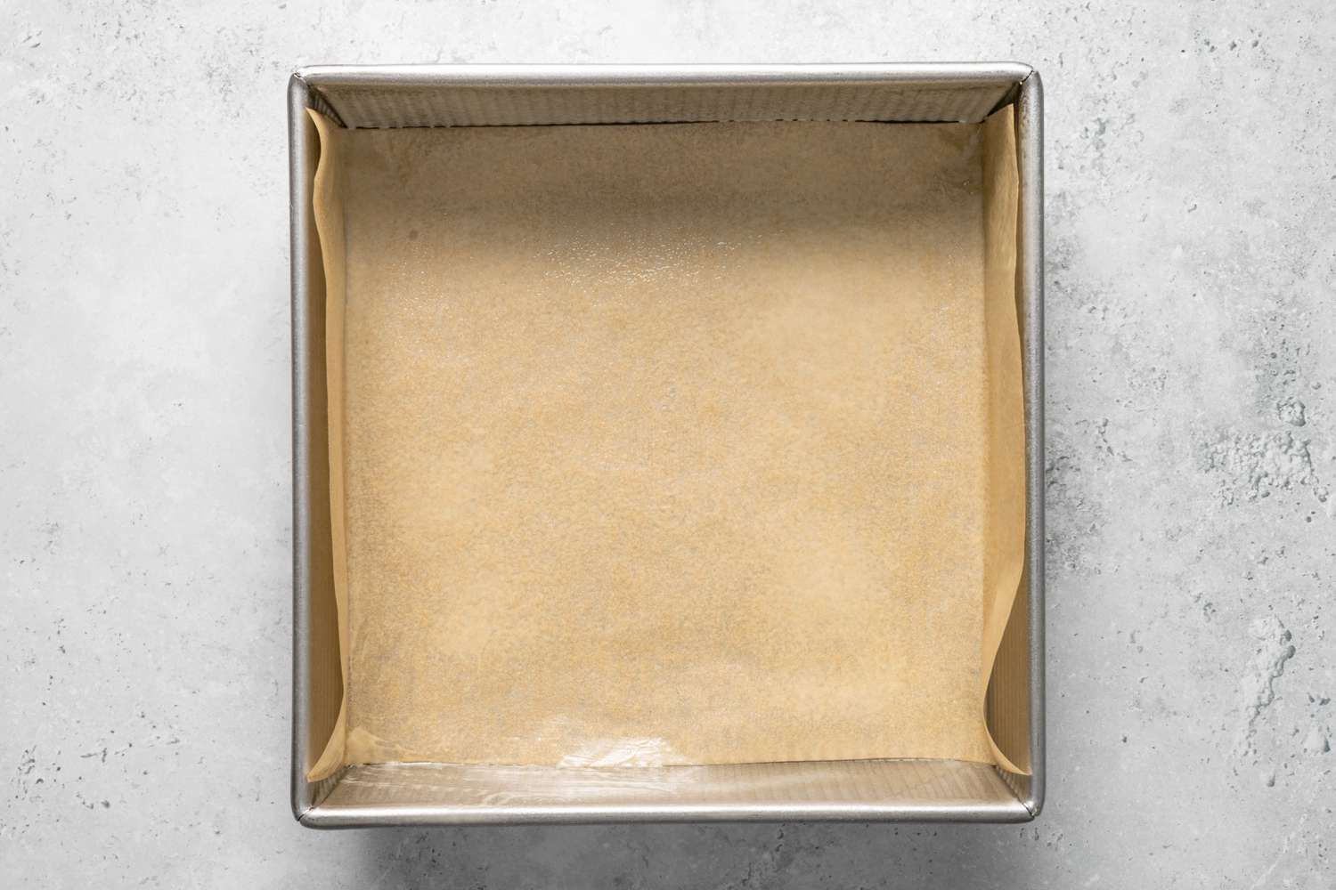 Baking Pan Greased and Lined with Parchment Paper for Brownie Layer of Brownie Banana Bread Recipe