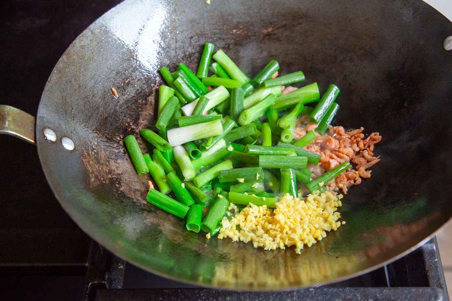 Napa Cabbage with Dried Shrimp being cooked in a wok.