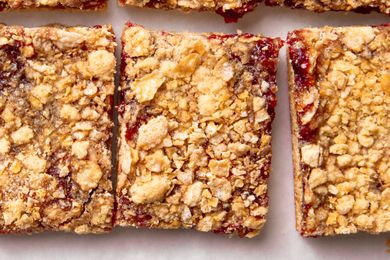 Crispy topped raspberry jam bars arranged in close up view