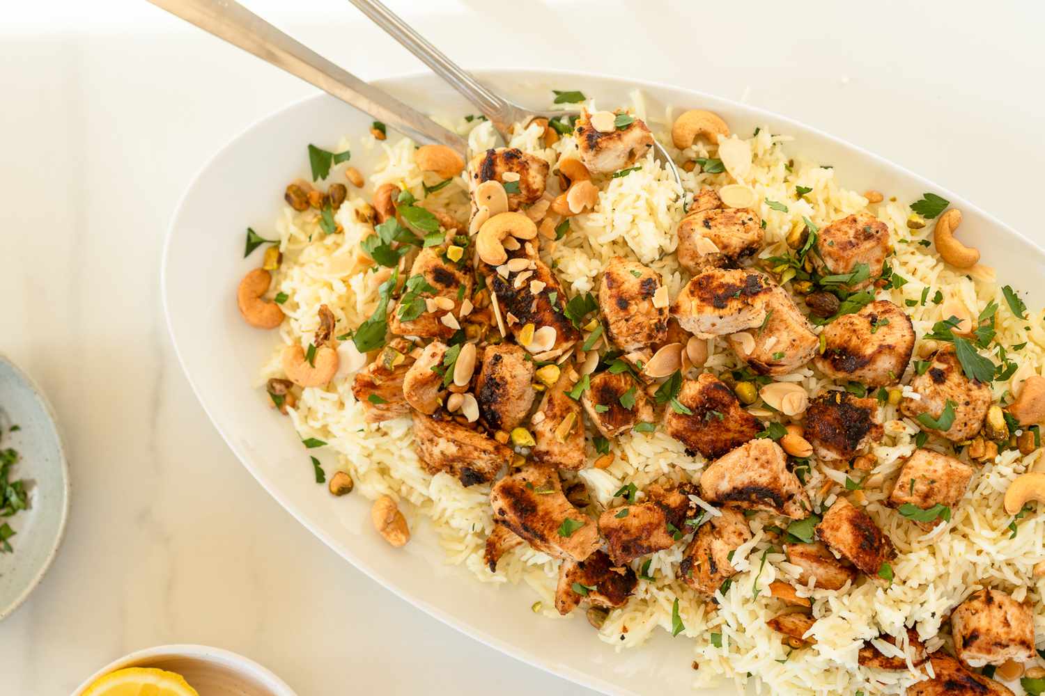 Overhead shot of a large serving plate with chicken chunks over rice