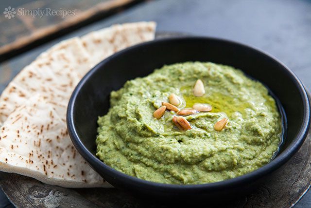 Basil Hummus in a bowl with pita on the side