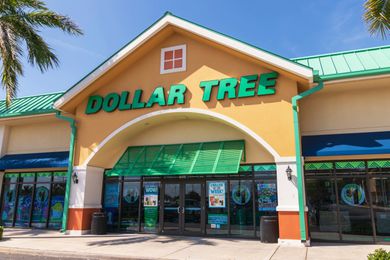 A Dollar Tree storefront in a commercial area, featuring arched design and green accents