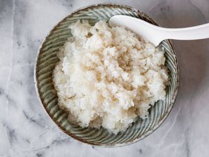 Sushi Rice in a Bowl with a Rice Paddle