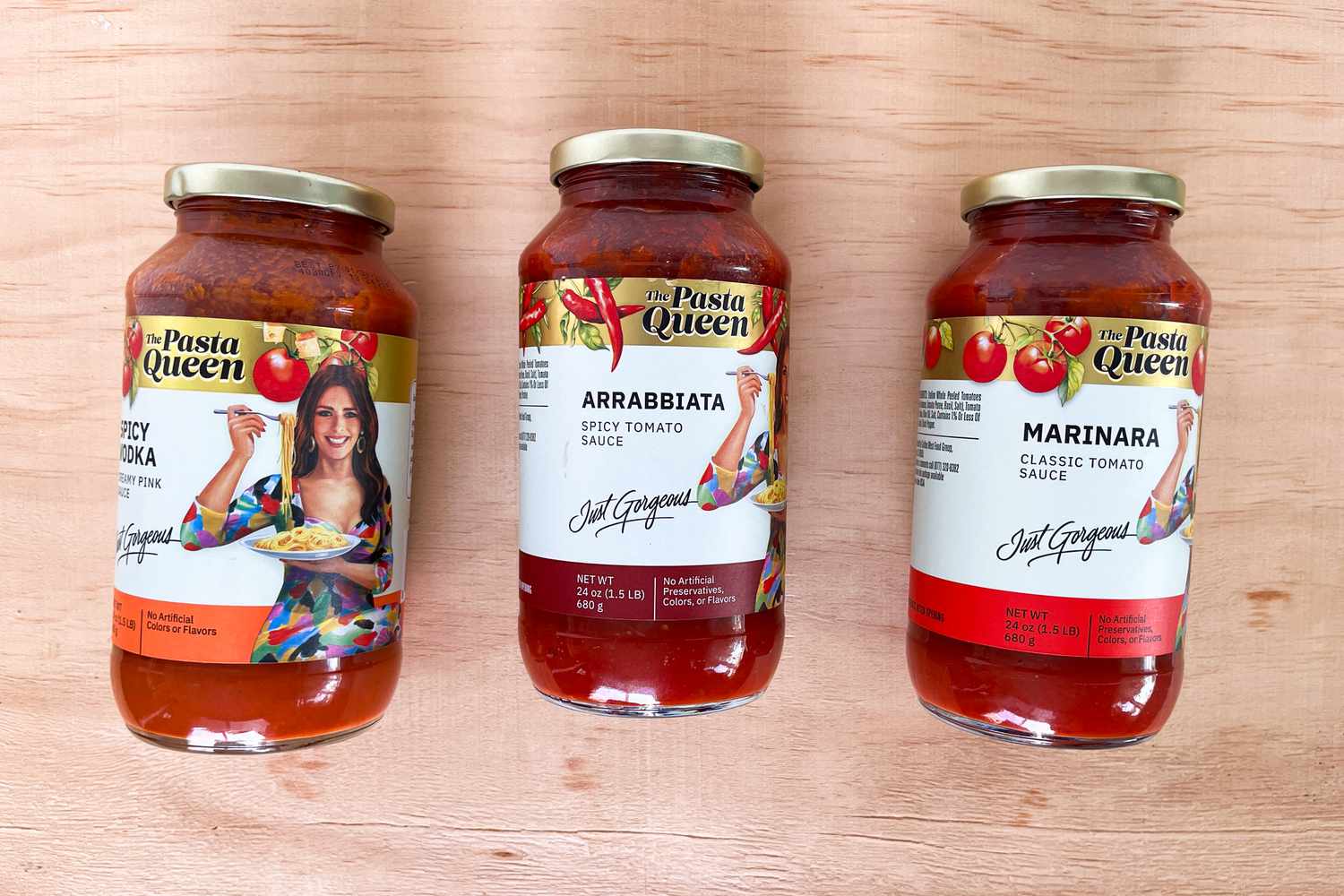 Three jars of Pasta Queen pasta sauces in a row: Spicy Vodka, Arrabbiata, and Marinara