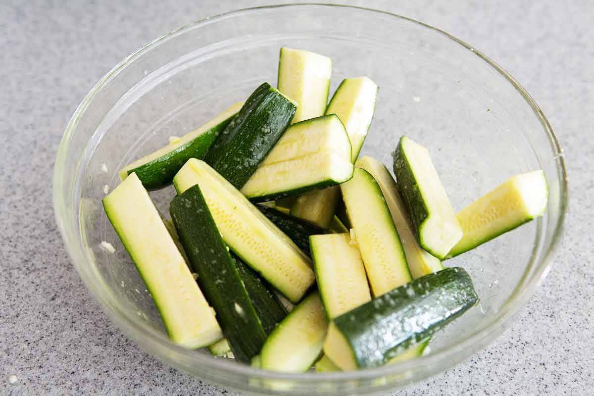 Toss the zucchini with garlic and olive oil in a bowl