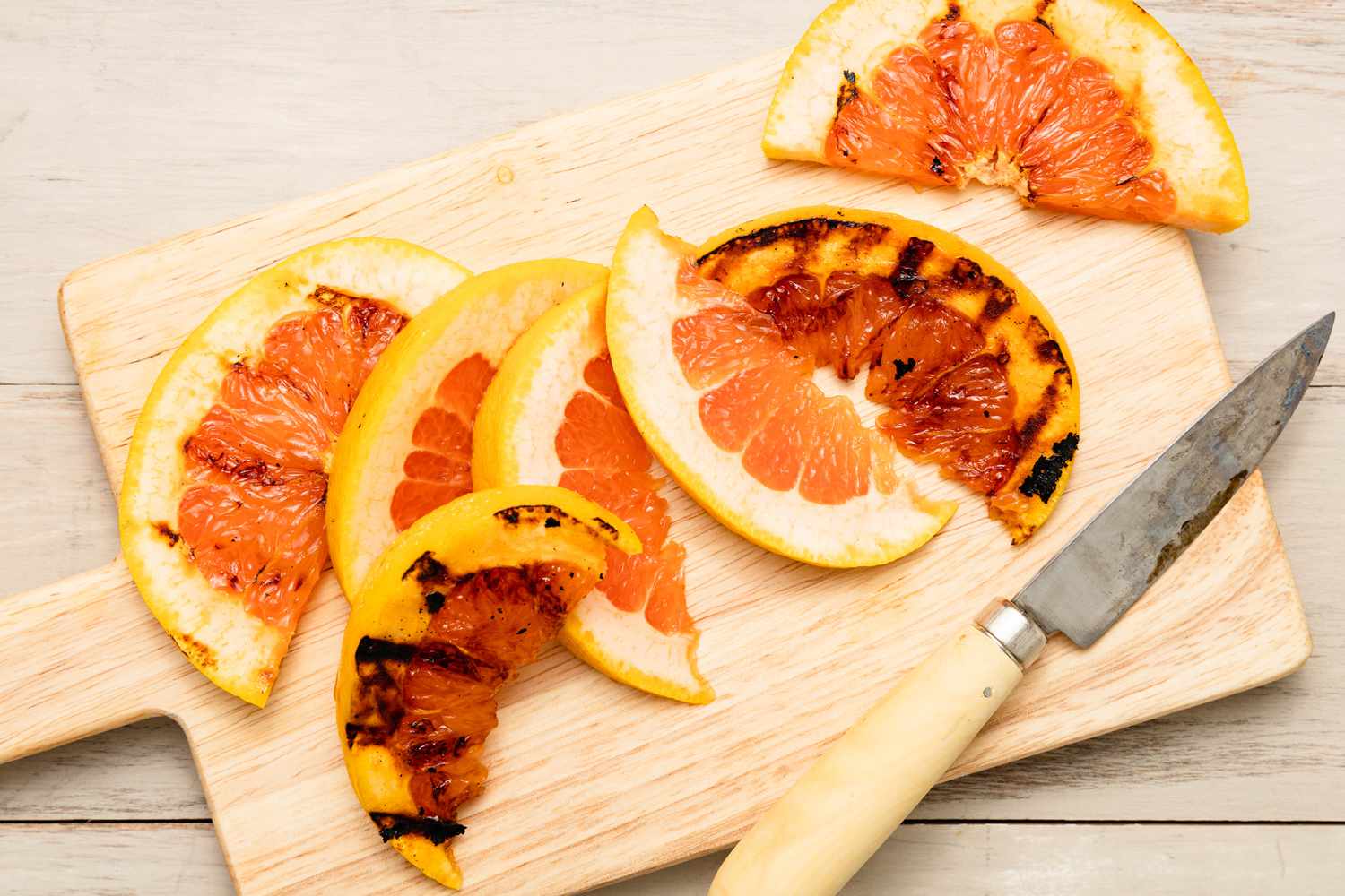 Grapefruit Half Cut Into Slices on a Cutting Board 