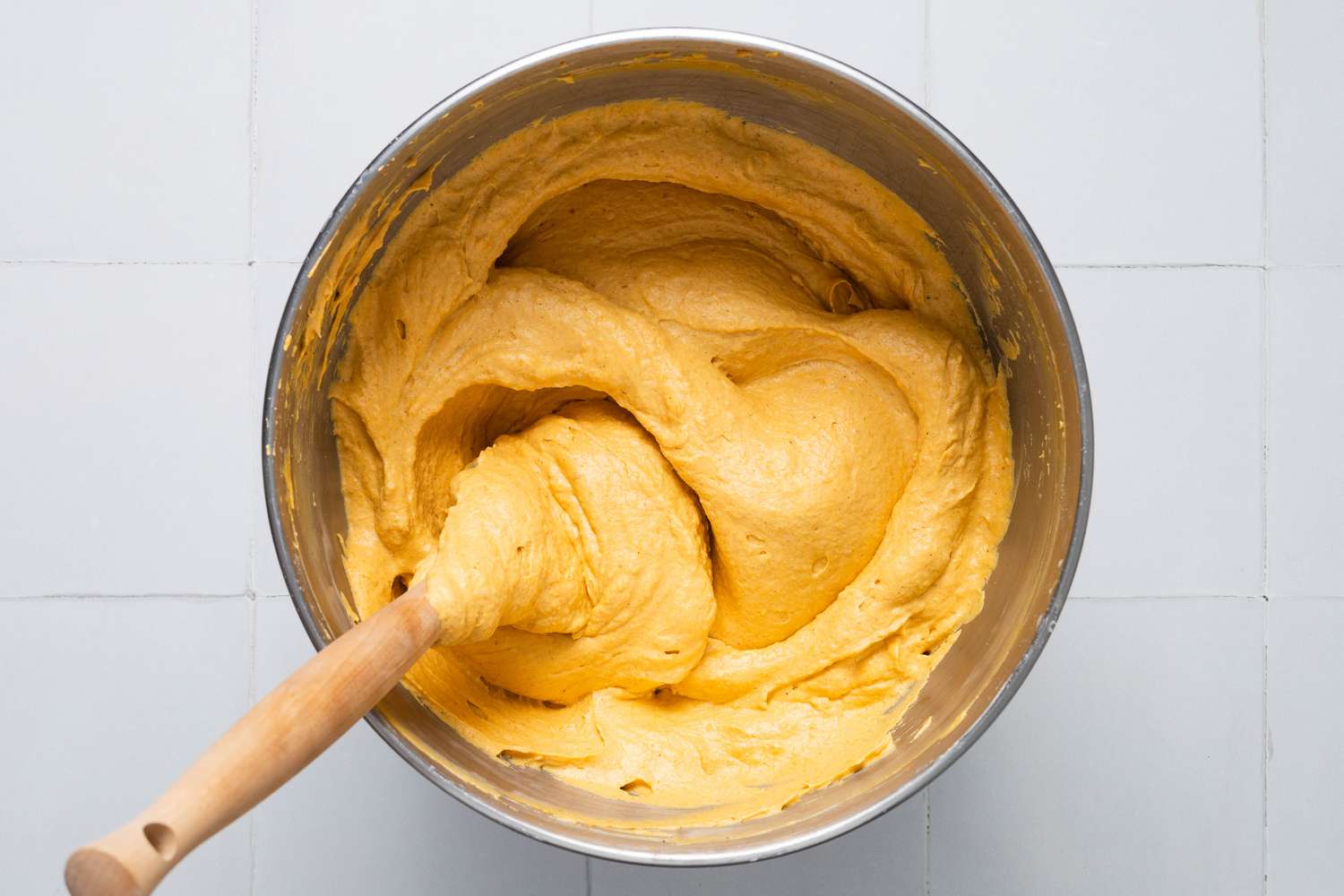 No-bake pumpkin cheesecake filling in a bowl with a spatula