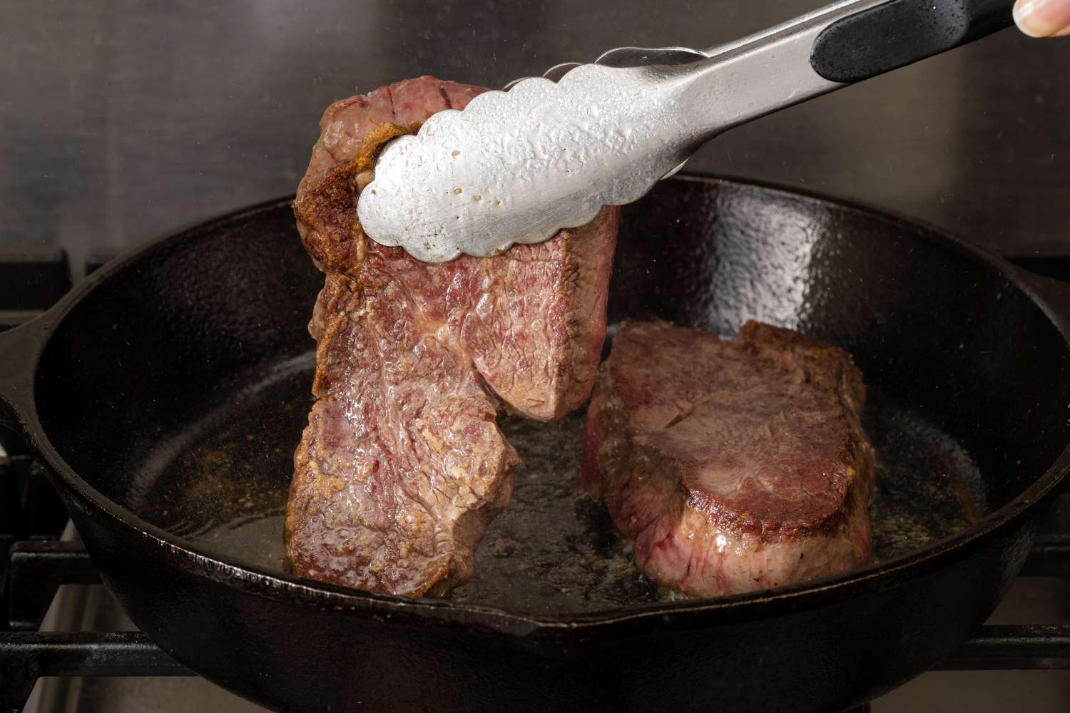 Cooking Filet Mignon steaks on the stove in a skillet