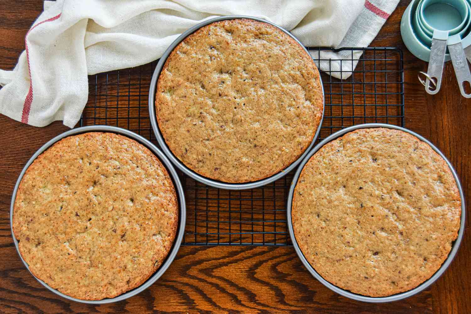 Overhead view of three southern hummingbird cake layers set on a cooling rack.