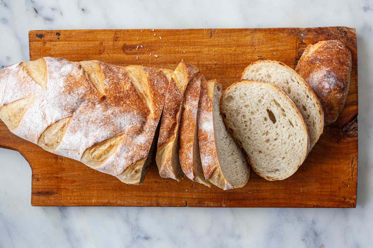 Sliced bread on a cutting board to make Spanish Style Migas.