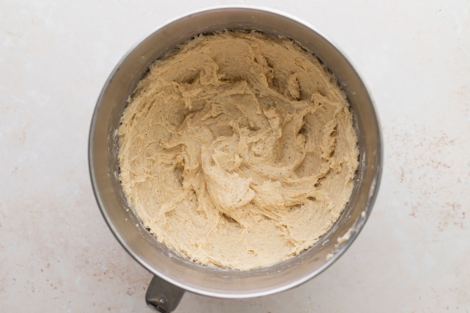 Overhead view of a mixing bowl with dough to make a Danish kringle recipe.