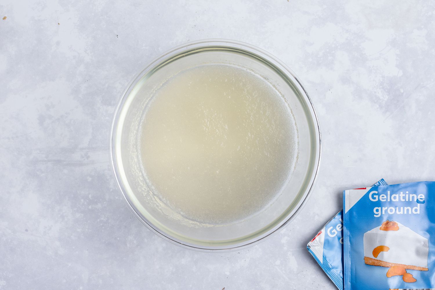A glass bowl with gelatin to make the no bake cheesecake filling.