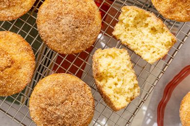 Old-Fashioned Donut Muffins on a cooling rack, one broken open