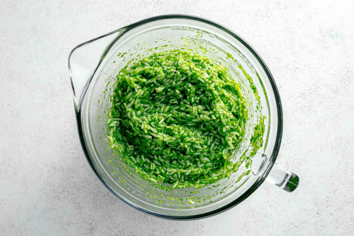 Smooth Herb Mixture Mixed with Cooked Rice in Microwavable Measuring Cup for Microwave Arroz Verde Recipe