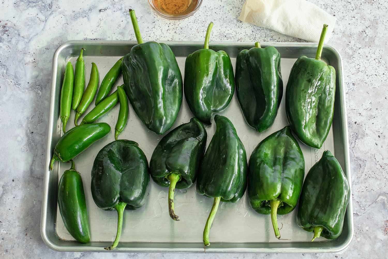 Poblano Peppers, Serrano Peppers, and Jalapenos on a Baking Tray for Poblano, Corn, and Cheese Tamales Recipe