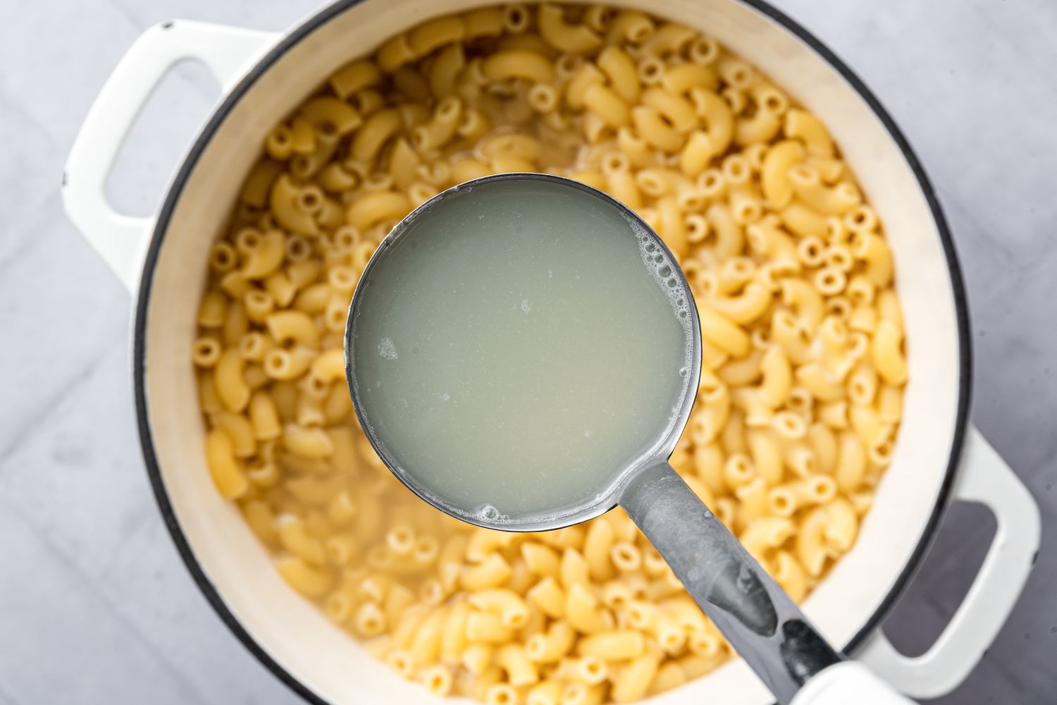 A Ladle of Pasta Water Removed to Reserve for Vegan Mac and Cheese