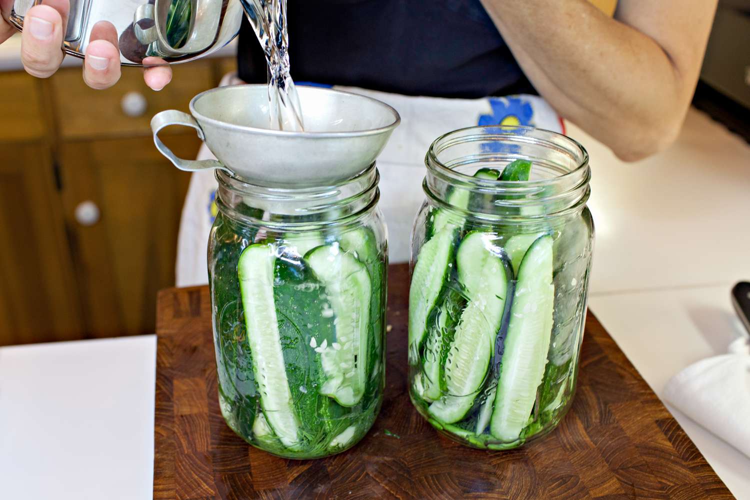 Pickling Brine Funneled into Jars of Cucumbers for Fermented Pickles