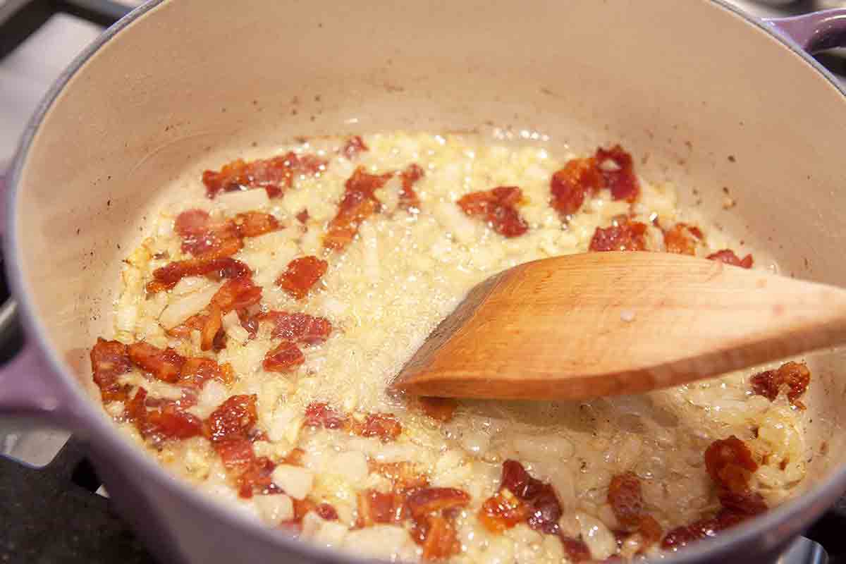 onions and bacon cooking in pot for baked beans