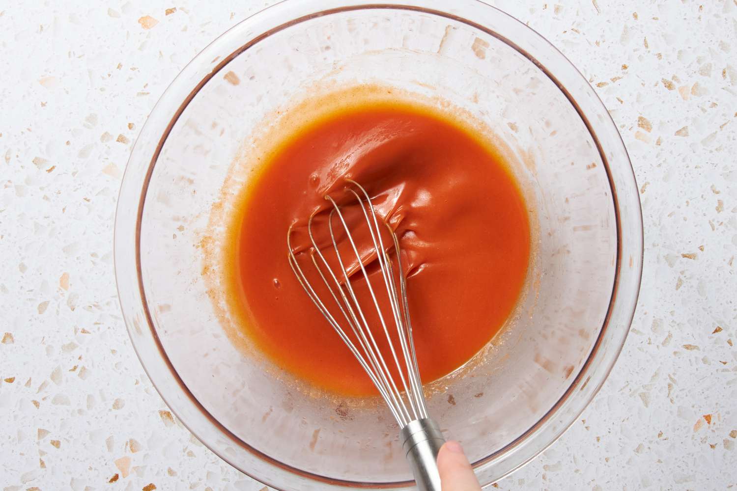 Bowl of Buffalo Sauce and Melted Butter Whisked Together for Buffalo Taco Recipe