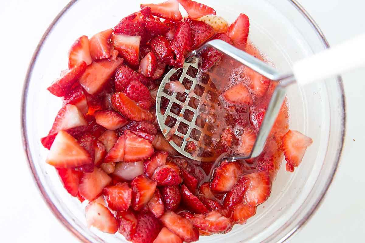 mashing strawberries for shortcake recipe