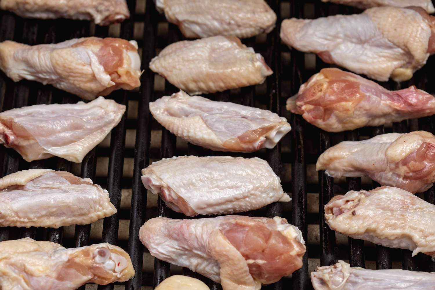 Chicken wings set on a grill to show how to grill chicken wings.