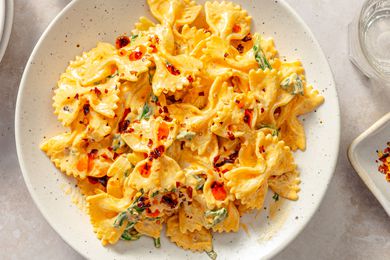A plate of farfalle pasta with chili crisp seasoning and a creamy sauce