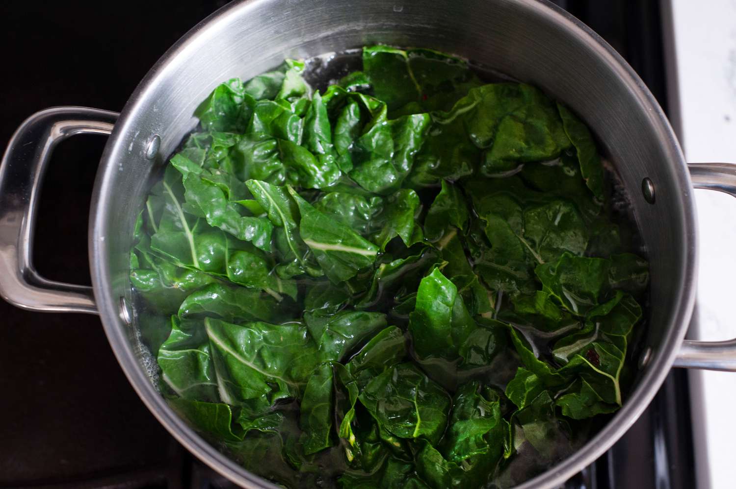 Blanching swiss chard to make lemony swiss chard sauce pasta.