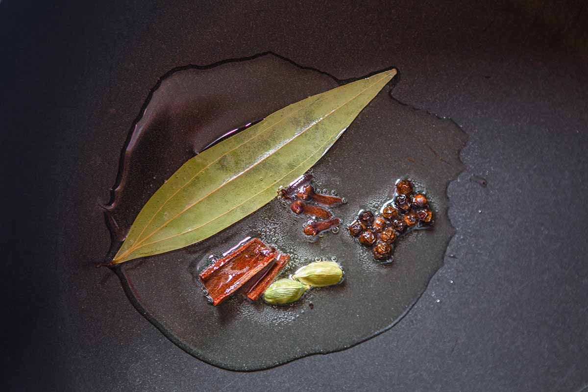 Authentic Chicken Korma Recipe - herbs blooming in oil