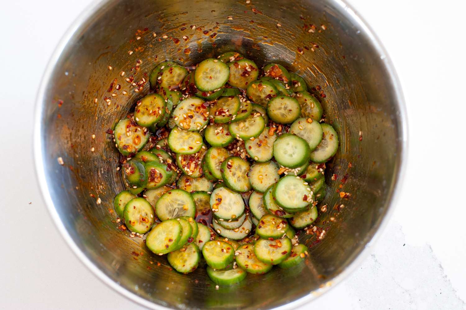 Cucumbers with chili crisp and seasonings.