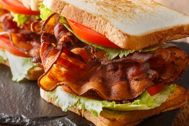 Closeup of a BLT sandwich with crispy bacon, tomato slices, lettuce, and toasted bread