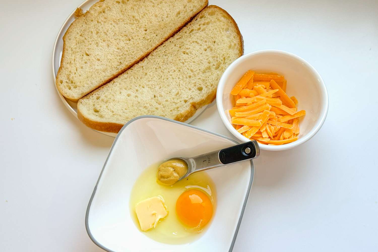 The ingredients for Jane Austen's cheese toastie: bread, an egg, mustard, butter, and cheese
