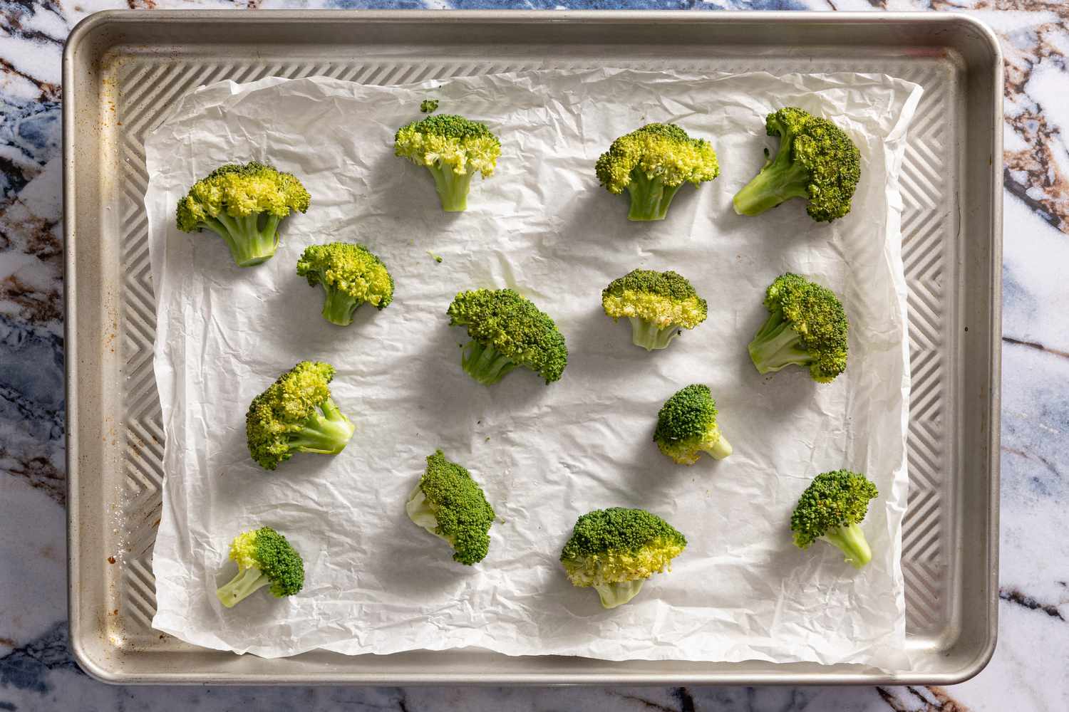 parchment packed opened to reveal steamed broccoli for crispy parmesan broccoli recipe