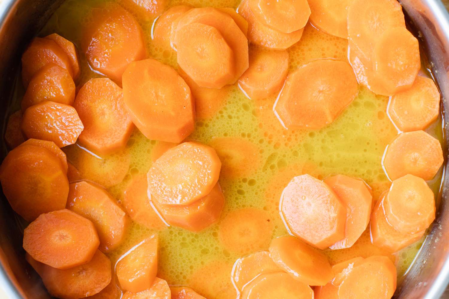 Overhead view of a skillet of cooked carrots.