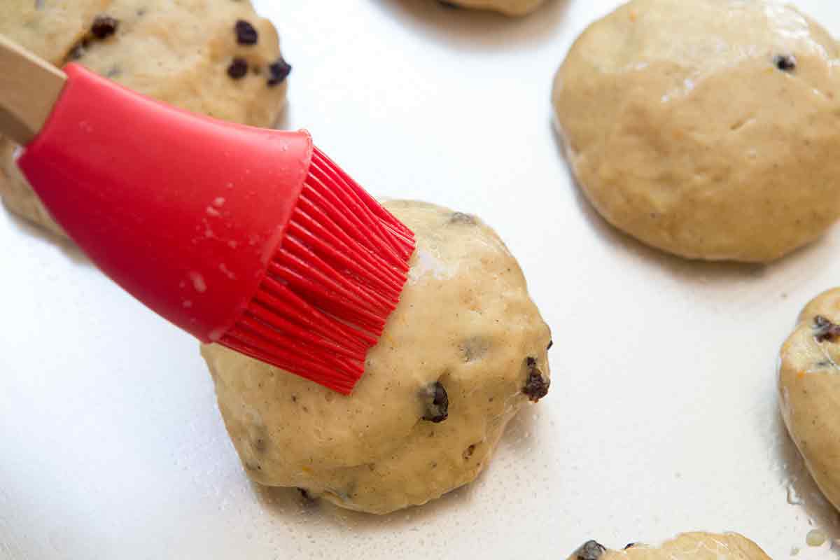Brush the top of the hot cross buns with egg glaze before baking