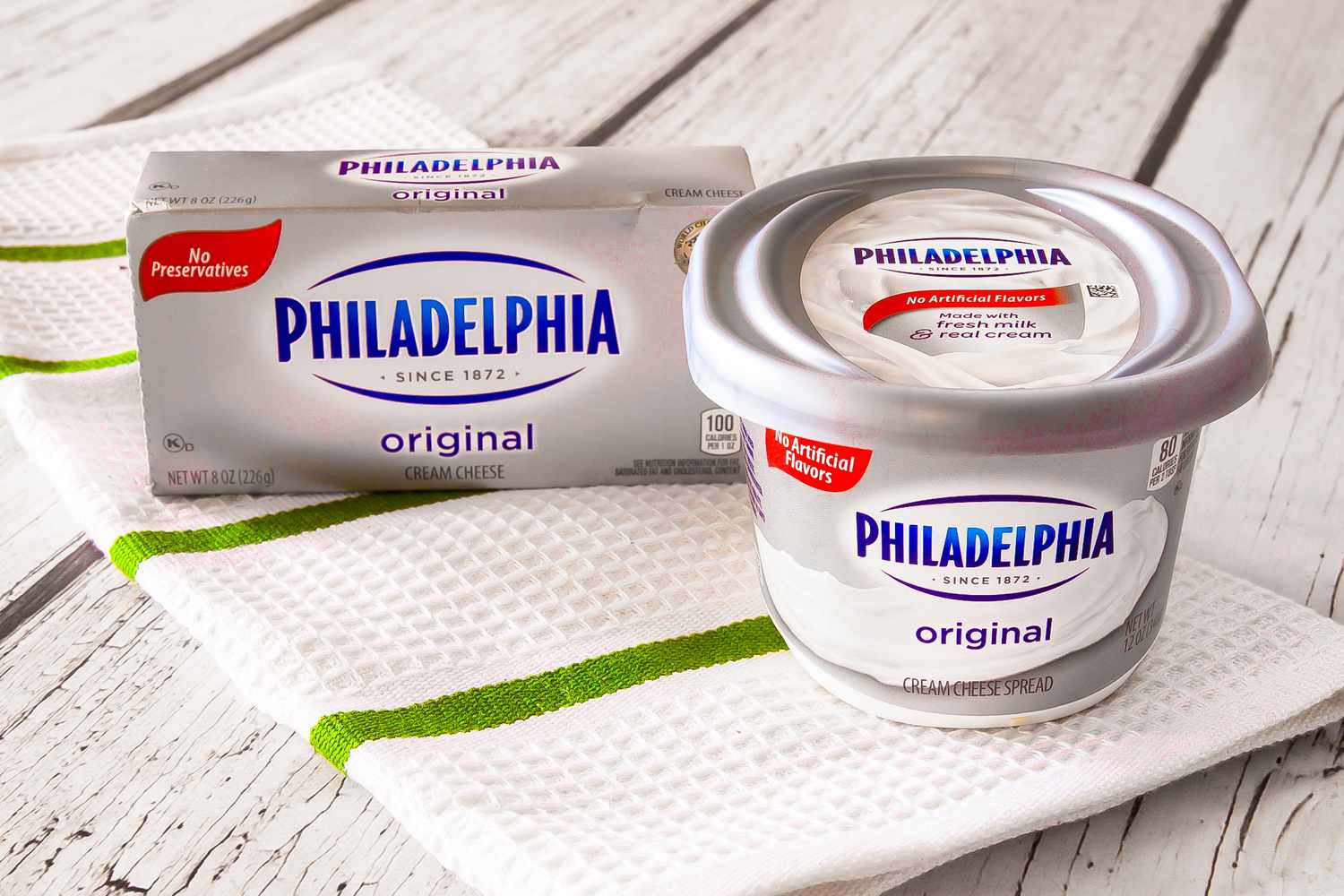 Philadelphia cream cheese (box and container, side by side) on the counter