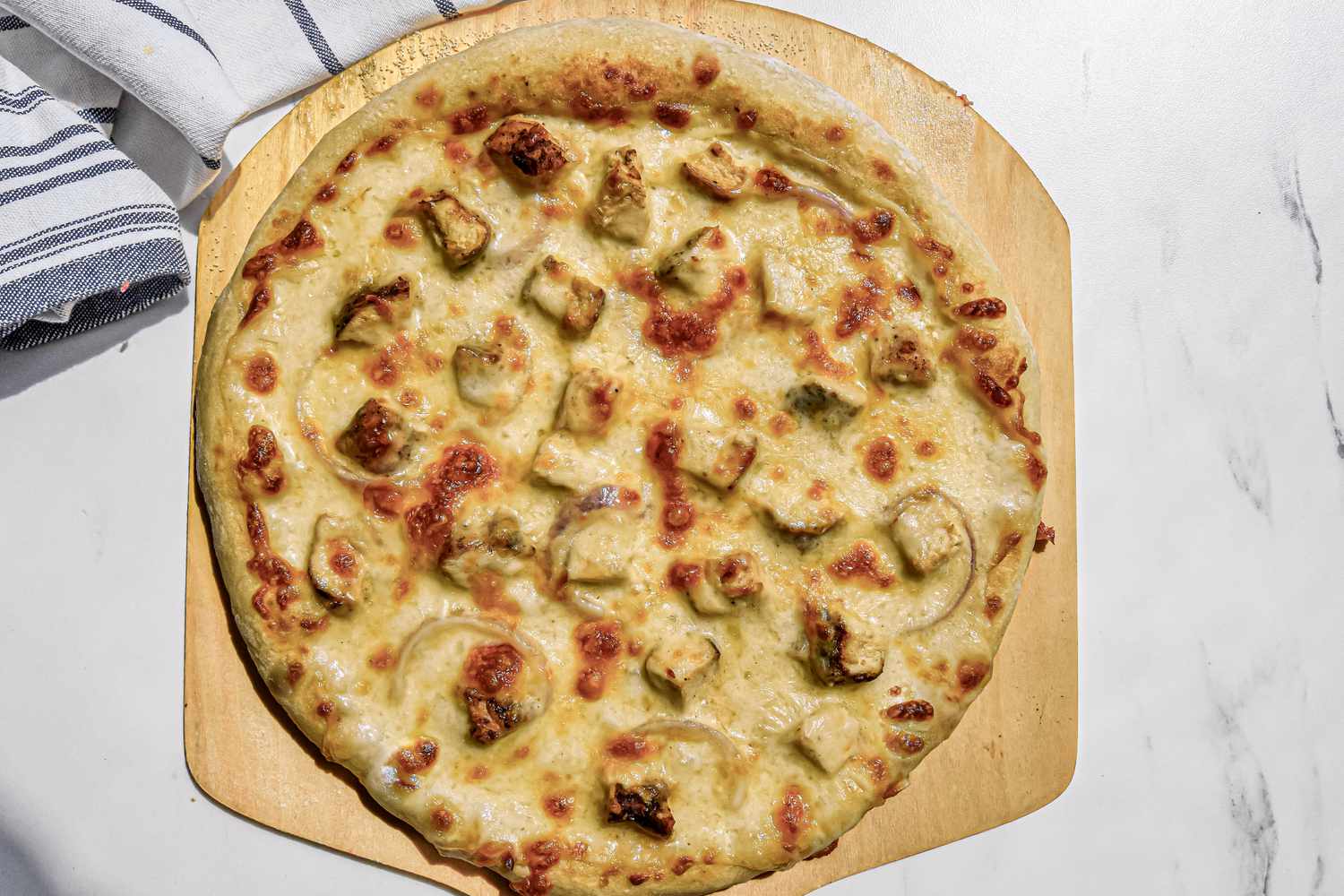 Baked Chicken Alfredo Pizza on the Pizza Peel