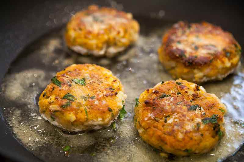 shrimp cakes being fried in oil