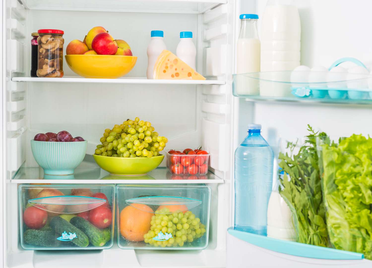Inside of a fridge filled with different foods and drinks