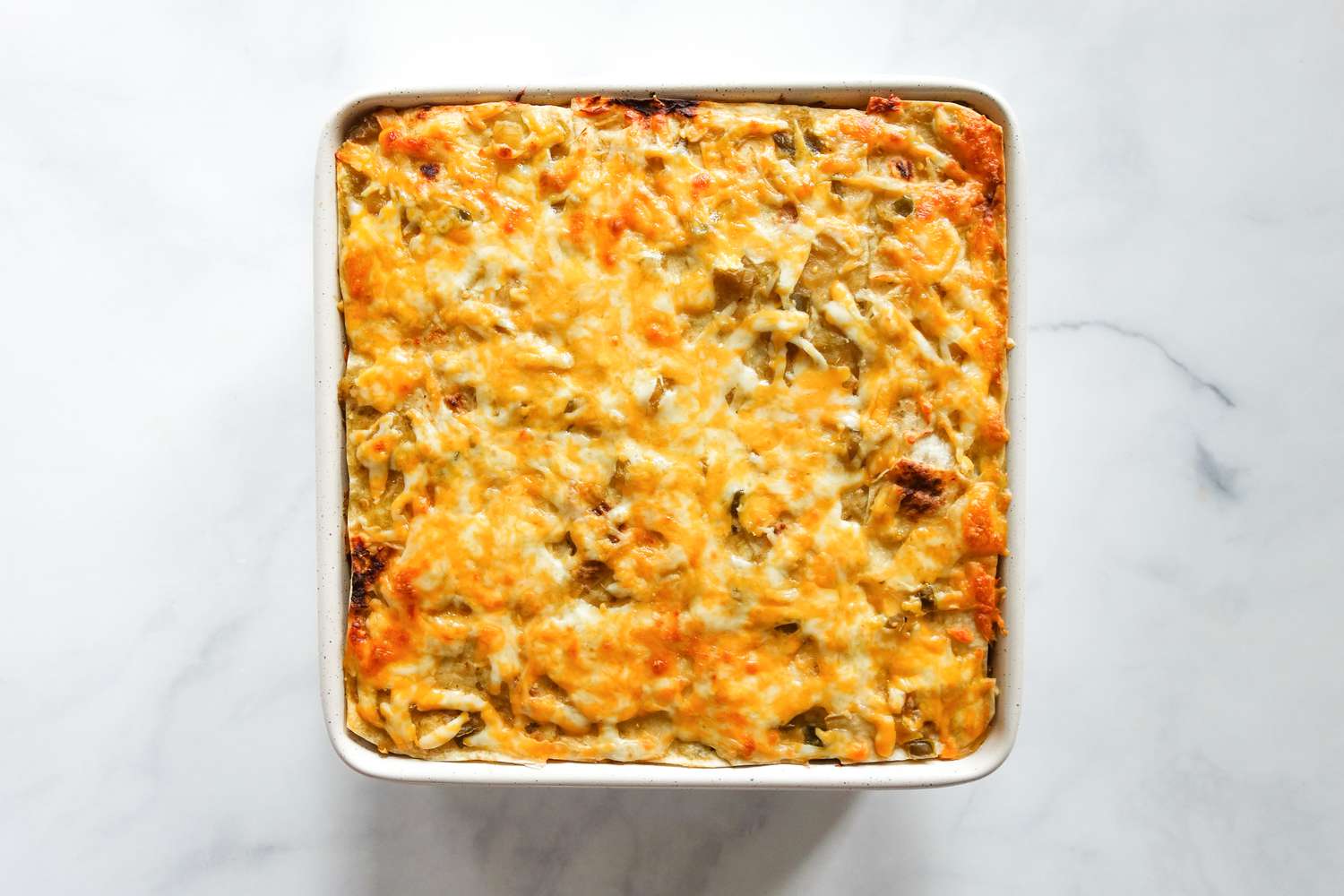 Baked burrito casserole in baking dish.