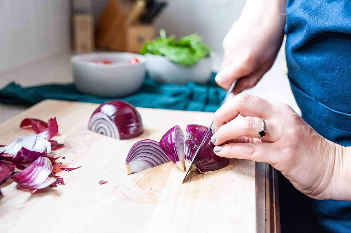Easy Skillet Chicken-woman slicing red onion with knife