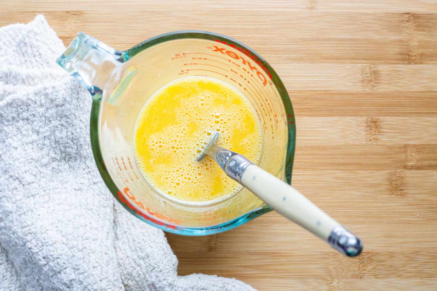 Egg Whisked in Measuring Cup with Fork for Denver Omelet
